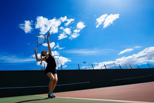 Happy beautiful sexy girl playing tennis on the court. Sport and recreation, leisure.