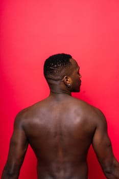 A handsome and muscular young man posing in a studio.