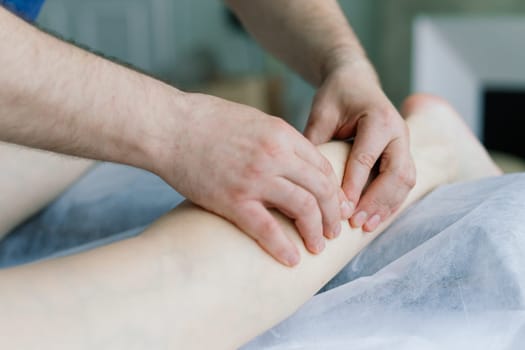 Anti-cellulite foot massage for fat woman. Concept of personal care, weight loss, diet. Close-up.
