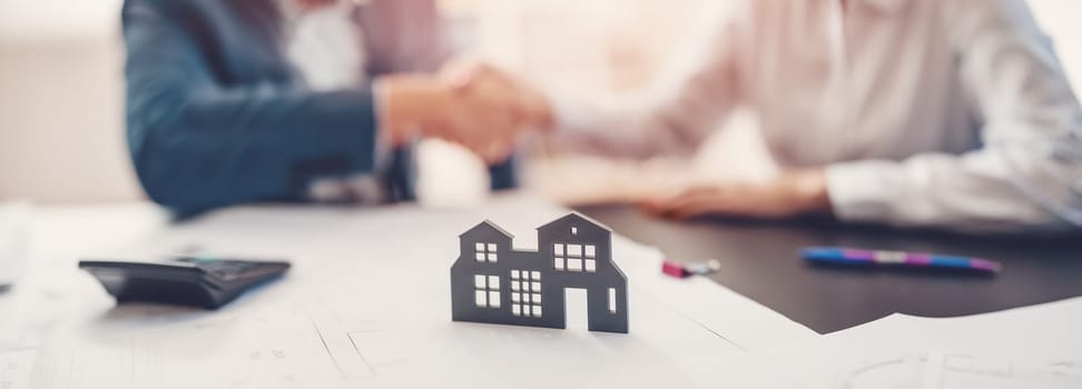 Handshake between two people concluding a contract for the sale of housing. Concept of the real estate and buying new apartment.