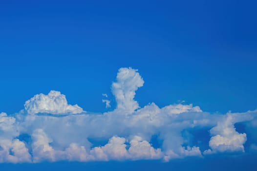 White cumulus clouds against the blue sky. White clouds. Blue sky. Fluffy cloud. Clear sunny day. Weather. Weather forecast. Summer season. Beauty in nature. Outdoors.
