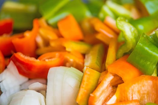 sliced carrots, peppers and onions in a closeup