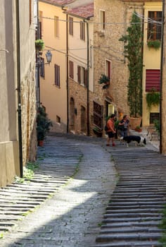 Massa Marittima, Italy - Sept 11, 2022: Steep and narrow street in old town of Massa Marittima, Italy
