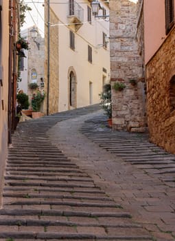 Massa Marittima, Italy - Sept 11, 2022: Steep and narrow street in old town of Massa Marittima, Italy