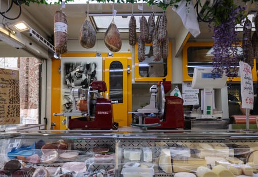 Cremona, Italy - September 7, 2022: Traditional meat products sold at a street stall during the farmers market in Cremona, Lombardy, Italy