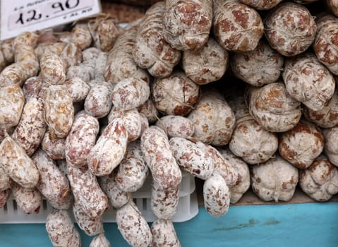 Cremona, Italy - September 7, 2022: Traditional meat products sold at a street stall during the farmers market in Cremona, Lombardy, Italy