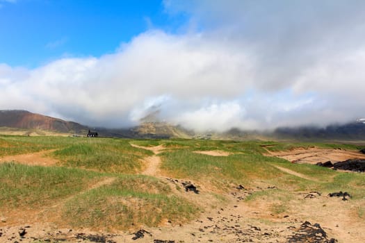 Sand dunes at the beach of Budir, clouds hanging low, Snaefellsnes National Park