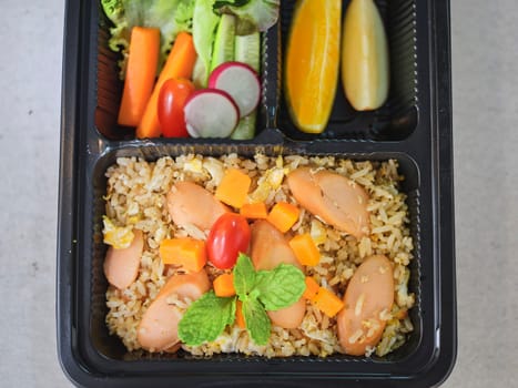 Fried rice with sausage and mixed vegetable .