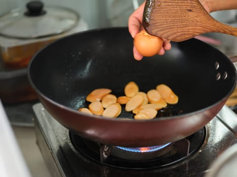 Cooking of sausage fried rice and crack an egg  with mixed vegetable .
