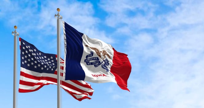 Flags of Iowa and the United States waving in the wind on a clear day. State in the upper Midwestern region of the United States. 3d illustration render. Fluttering fabric.