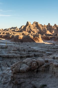 Jagged sandstone mountains illuminated from the sun in Badlands National Park, USA