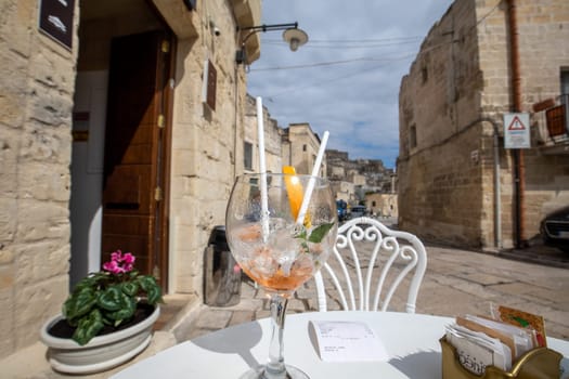 Matera, Italy - September 20, 2019: Aperol Spritz drunk on an empty table in a cafe in Matera. Basilicata. Italy