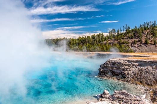 Bright azure colored hot pool in Yellowstone National Park, USA