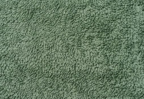 Texture of a green terry cotton towel, canvas. Macro