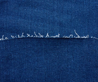 Texture of blue jeans with thread
