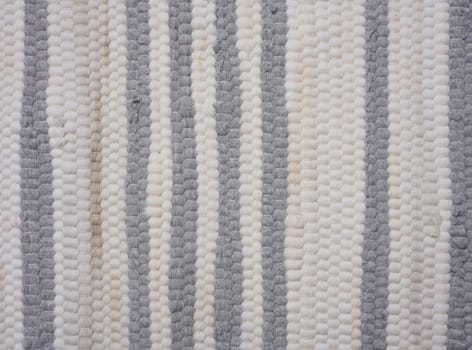 Fragment of a knitted white-gray fabric, close up