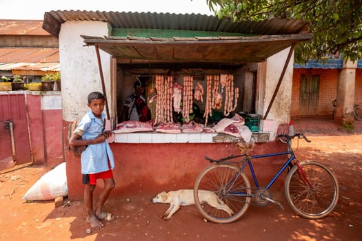 Mandoto, Madagascar - November 9th, 2022: The shop displays sausages on a stand that hang in the heat of the day.