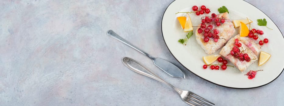 Cod fillet without skin baked with red currants. Cod fish, space for text.