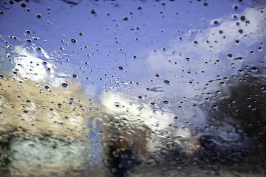 Detail of car glass wet from the rain, cold in winter