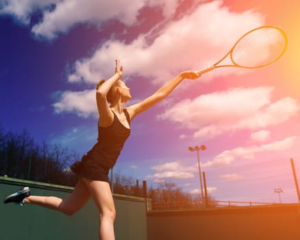 Sexy girl tennis player in white dress and heels holding tennis racket on the court. Young woman is playing tennis, sport