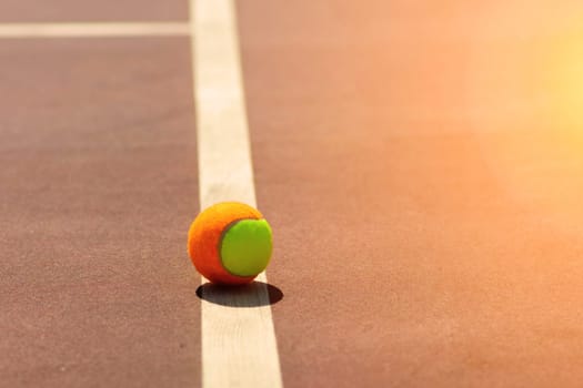 Tennis balls and rocket on court field in sunny day, sport, hobby