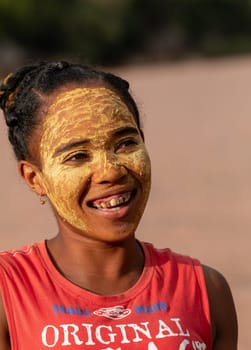 Bekopaka, Madagascar - November 4. 2022: Malagasy woman in ferry on rover Mania. Malagasy women paint their faces to protect their faces from the sun.