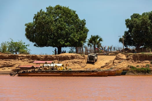 Port Bac Belo Sur Tsiribihina, Madagascar - November 4th, 2022: A ferry carrying passengers and cars travels on the port Tsiribihina on River Mania in Madagascar.