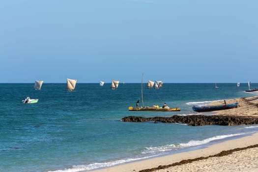 ANAKAO, MADAGASCAR - NOVEMBER 24, 2022: Fishermen using sailboats to fish off the coast of Anakao in Madagascar. The primary source of livelihood in Anakao is fishing.