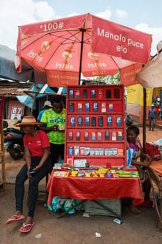 Mandoto, Madagascar - November 2nd 2022: Malagasy woman sell old fashioned cellular mobile phones on the street of Mandoto.