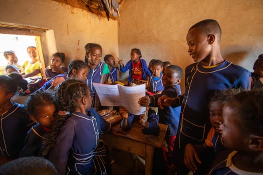 Vohitsaoka, Ambalavao, Madagascar - November 17. 2022: Happy Malagasy school children students in classroom. School attendance is compulsory, but many children do not go to school.