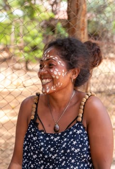 Miandrivazo, Madagascar - November 2nd 2022 - Close up portrait of a Malagasy woman with white dots painted on her face as part of a traditional culture.