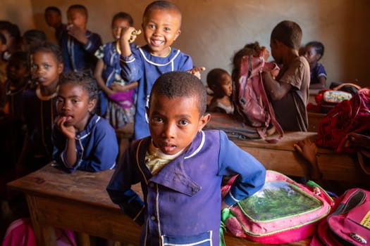 Vohitsaoka, Ambalavao, Madagascar - November 17. 2022: Happy Malagasy school children students in classroom. School attendance is compulsory, but many children do not go to school.