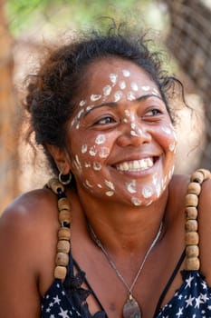 Miandrivazo, Madagascar - November 2nd 2022 - Close up portrait of a Malagasy woman with white dots painted on her face as part of a traditional culture.