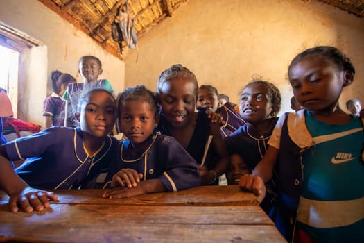Vohitsaoka, Ambalavao, Madagascar - November 17. 2022: Happy Malagasy school children students in classroom. School attendance is compulsory, but many children do not go to school.