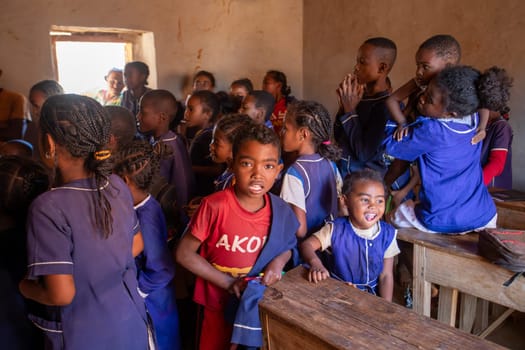 Vohitsaoka, Ambalavao, Madagascar - November 17. 2022: Happy Malagasy school children students in classroom. School attendance is compulsory, but many children do not go to school.