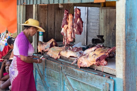 Miandrivazo, Madagascar - 02/11/2022: A hot day in Miandrivazo, Madagascar, with a street stall butcher shop open with raw meat.