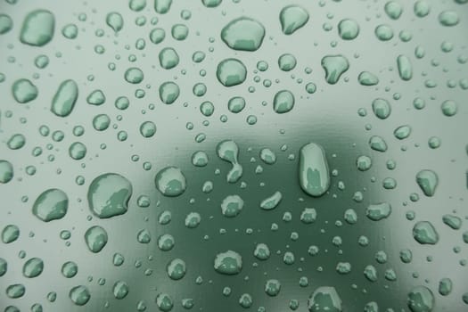 Detail of raindrops on a metallic background, cold and winter