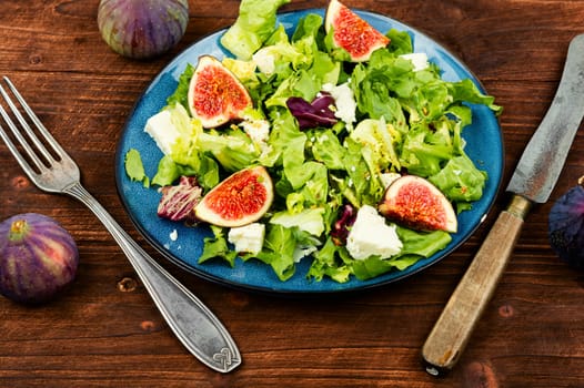 Appetizer homemade salad with figs, herbs and cheese.