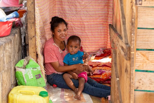 Miandrivazo, Madagascar - November 2. 2022: Young mother with their children in front of their house.