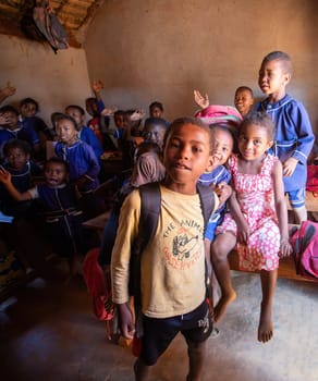 Vohitsaoka, Ambalavao, Madagascar - November 17. 2022: Happy Malagasy school children students in classroom. School attendance is compulsory, but many children do not go to school.