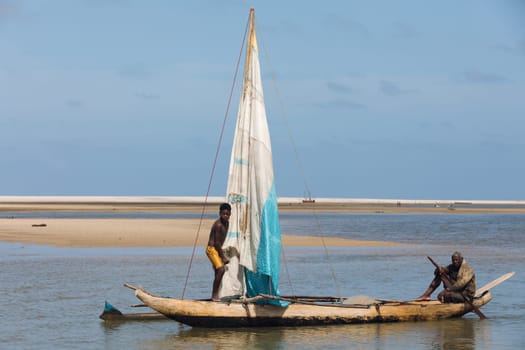 Morondava, Madagascar - November 3rd 2022: A fisherman sails back from the sea to the river on a sailboat in Morondava