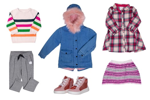 Collage set of little girl autumn or spring clothes isolated on white. Kids apparel collection. Childs fashion clothing outfit. Jeans jacket, skirt, shirt, dresses and shoes.