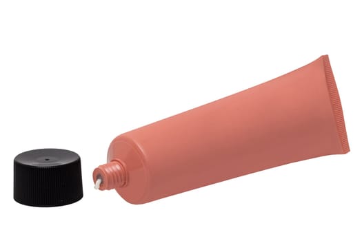 Cosmetic products isolated. Close-up of a opened pink tube cosmetic cream with a skin care product for face isolated on a white background. Space for text.Macro.