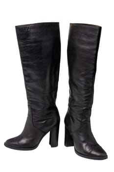 A pair of black elegant female boots or woman shoes isolated on a white background. Leather boots.