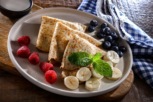A plate of home-made Polish pancakes filled with sweet cottage cheese