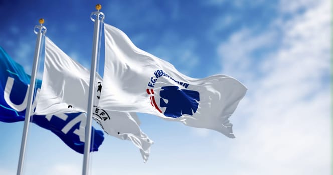 Copenhagen, DK, August 31 2023: Flags of the Copenhagen football club, UEFA and the Champions League fluttering in the wind. Illustrative editorial 3d illustration render
