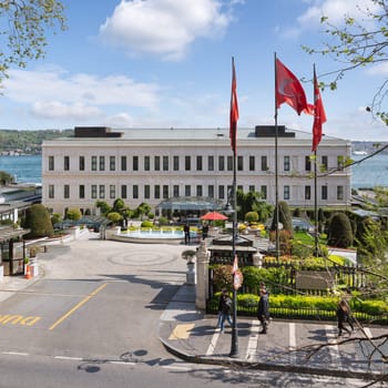 Istanbul, Turkey - May 7, 2023: View from Ciragan street of modern architectural design five stars Four Seasons hotel, suited by Bosphorus Strait, at Besiktas district, in a spring day