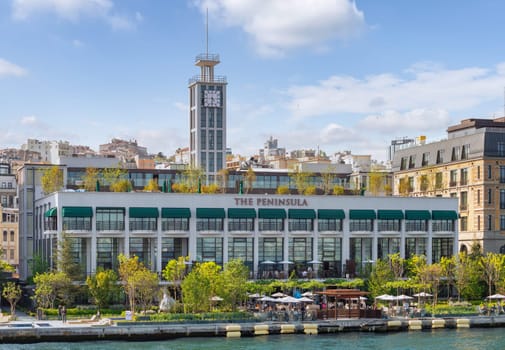 Istanbul, Turkey - May 7, 2023: Exterior of Peninsula five stars hotel, suited by Bosphorus Strait, beside Galataport, in a spring day