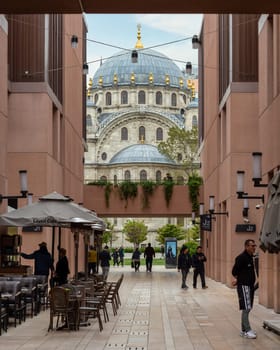 Istanbul, Turkey - May 5, 2023: Nusretiye imperial Ottoman Mosque framed by internal passage at Galataport, a mixed use development located along shore of Bosphorus strait, in Karakoy district