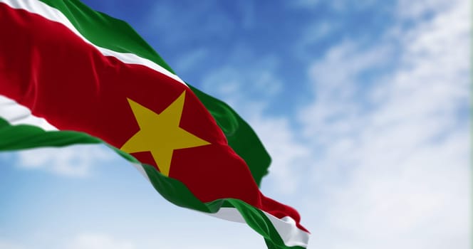 Suriname national flag waving in the wind on a clear day. 5 horizontal bands: green, white, red, white, green, yellow star in the center. 3D illustration render. Fluttering textile. Selective focus
